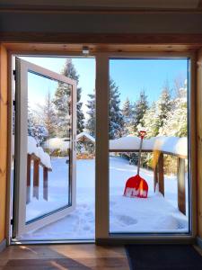 a window with a view of a snow covered yard at Domki Wetlina 21 in Wetlina