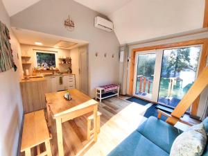a living room with a table and a blue couch at Domki Wetlina 21 in Wetlina