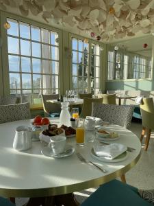 a table with breakfast food on it in a restaurant at Suites du Cabinet Vert in Orléans +28 photos