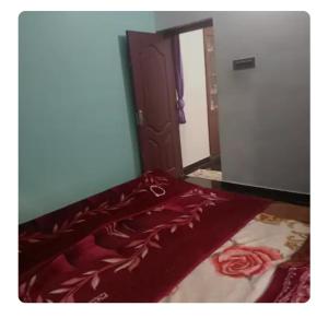 a bed with a red blanket on top of it at Dream Home in Irimbranallūr
