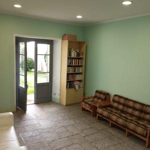 a living room with a couch and a book shelf at Quadrifoglio Center in Ameno