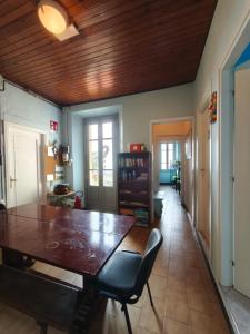 a dining room with a wooden table and chairs at Quadrifoglio Center in Ameno
