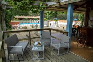 a patio with chairs and a table and a pool at Camping le Laha in Lesperon +11 photos