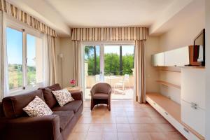 a living room with a couch and a large window at Elviria Hills Living in Marbella