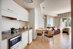 a kitchen and living room with a table and chairs at Elviria Hills Living in Marbella