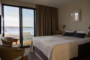 a hotel room with a bed and a large window at Skepparholmen Nacka in Nacka +25 photos