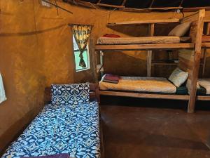a room with two bunk beds and a couch at Joy River Backpackers in Moremela