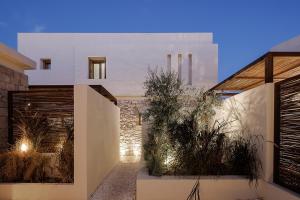 a white house with plants in front of it at The Village by WPS in Pollonia