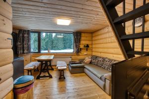 a living room with a couch and a table at Pod Horou a za Potokom, Podbanské in Pribylina
