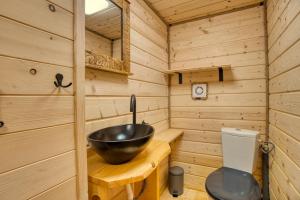 a wooden bathroom with a sink and a toilet at Pod Horou a za Potokom, Podbanské in Pribylina +7 photos