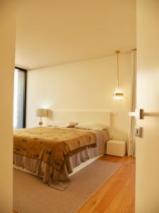 a bedroom with a large bed and a window at Casa da Merelhe in Marco de Canaveses +32 photos