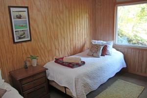 a bedroom with a bed and a window at Cabaña Fio-Fio Conguillio National Park in Conguillío