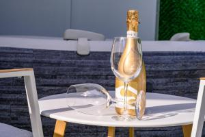 a bottle of champagne sitting on a table at אירוח תמר in Qiryat Shemona