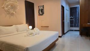 a bedroom with a bed with towels on it at VK House Rawai, Phuket in Rawai Beach