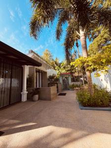 a house with palm trees and a patio at RV Regency 19 Hotel in Tangalle