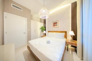 a bedroom with a large white bed and a table at 3BR Amazing Villa - Private Pool - 3WC - BBQ Pit in Sharjah +43 photos