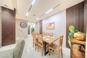 a dining room with a wooden table and chairs at 3BR Amazing Villa - Private Pool - 3WC - BBQ Pit in Sharjah