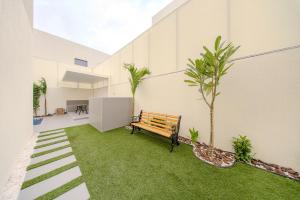 a bench sitting in the middle of a courtyard at 3BR Amazing Villa - Private Pool - 3WC - BBQ Pit in Sharjah