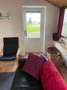 a living room with a couch and a window at The Old Barn in Hoevelaken