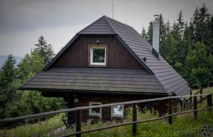 a house with a gambrel roof with a small window at PANORAMA RANČ in Ježíci