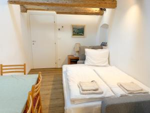 a small bedroom with a bed and a couch at Holy View Apartment in Bolzano