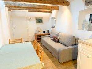 a living room with a couch and a table at Holy View Apartment in Bolzano