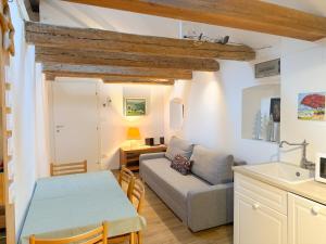 a kitchen and living room with a couch and a table at Holy View Apartment in Bolzano