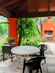 a white table and chairs on a patio at Arcadia in Merlo