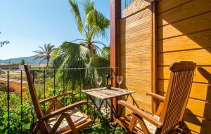 a table and two chairs with wine glasses on a porch at La Casa De Los Espejos in Capdepera