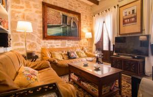 a living room with a couch and a tv at La Casa De Los Espejos in Capdepera +34 photos