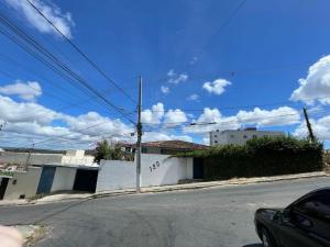 an empty street with a car parked on the road at Suite Brisa da Colina in Garanhuns
