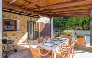 a patio with a table and chairs on a deck at Sa Gola in Canyamel