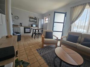 a living room with a couch and chairs and a table at 22 On Schwester Frieda in Swakopmund