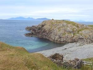 a rocky island in the middle of the ocean at Fascadale in Faskadale