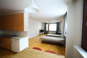 a kitchen and a living room with a couch at LibO-apartment, Rypys 74 X in Kuopio