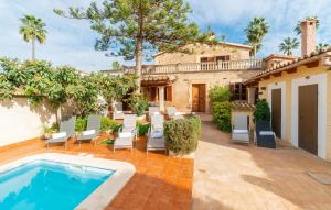 an outdoor patio with a pool and chairs and a house at Los Abilios in Palma de Mallorca