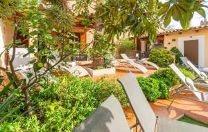 an outdoor patio with lounge chairs and trees at Los Abilios in Palma de Mallorca