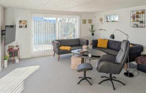 a living room with a couch and a table at 3 Bedroom Cozy Home In Haderslev in Haderslev