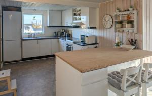 a kitchen with white cabinets and a large counter top at 3 Bedroom Cozy Home In Haderslev in Haderslev