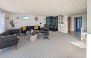 a living room with a couch and a table at 3 Bedroom Cozy Home In Haderslev in Haderslev