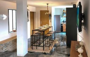 a dining room with a table and some chairs at Bel Appartement Reposant in Rambervillers +18 photos