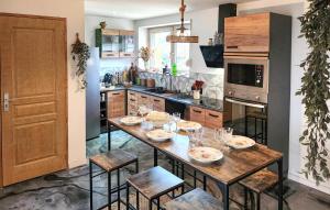 a kitchen with a table and chairs in a kitchen at Bel Appartement Reposant in Rambervillers