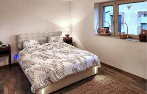 a bedroom with a bed with a white comforter at Bel Appartement Reposant in Rambervillers