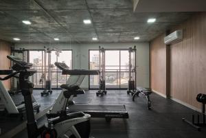a gym with treadmills and machines in a room at Apto Moderno no Coração da Cidade - CA802 in Maringá