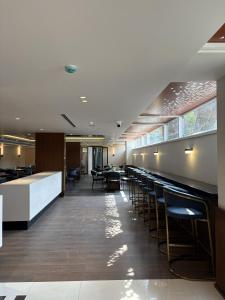 a bar in a restaurant with tables and chairs at Zipp Hotel Rosalba in Bangalore