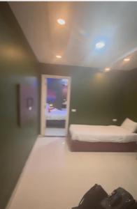 a room with a bed and a door with a window at Nile Plaza Guest House in Aswān