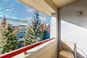 a window view of a christmas tree on a balcony at Town Plaza 427 in Whistler