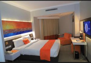 a hotel room with a large bed and a television at Nile Plaza Guest House in Aswān