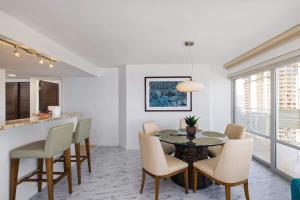 a dining room with a table and chairs at #Marbella Lane - Luxe 2BR with Panoramic Ocean View in Honolulu