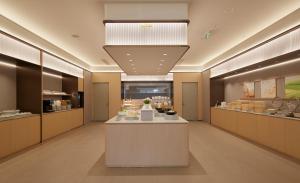 a lobby of a store with a cake on a counter at JI Hotel Vientiane Mekong Riverside in Vientiane
